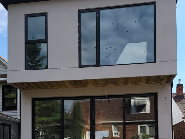 Professional stucco repair contractor working on a residential home exterior in Toronto